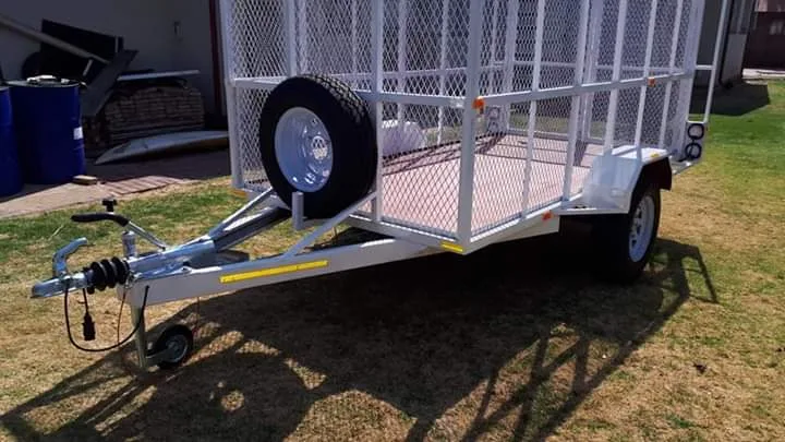 Steel cage trailer with mesh sides and spare wheel