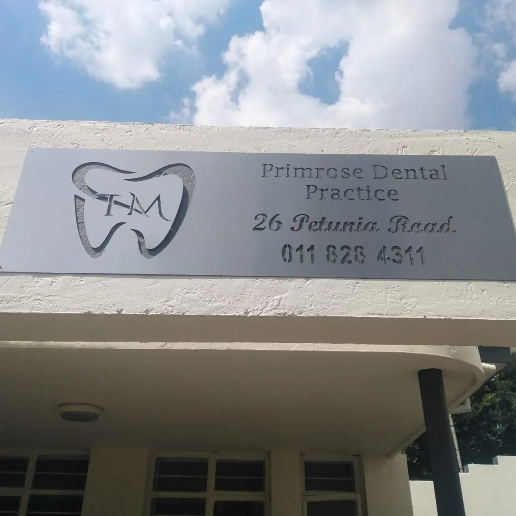 Dental practice sign mounted above a building entrance