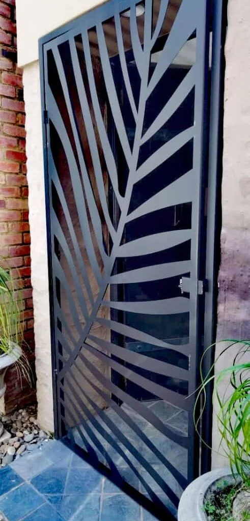 Decorative laser-cut steel pedestrian gate with leaf pattern