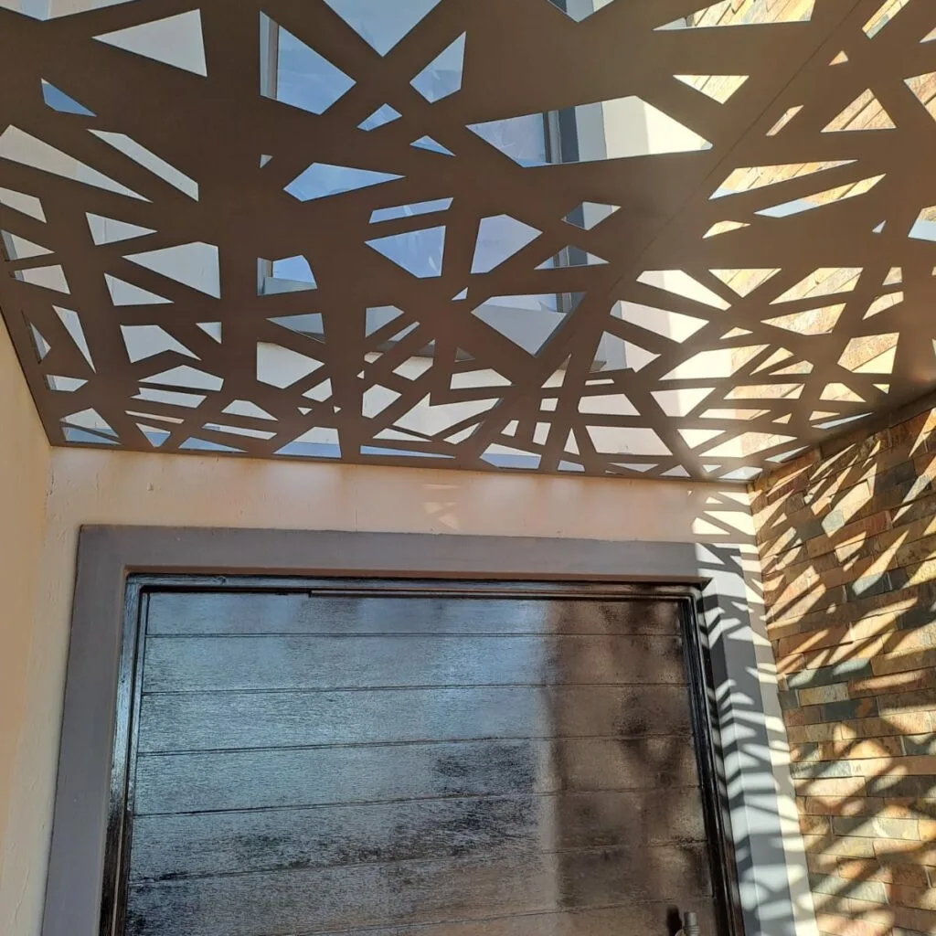 Patterned steel pergola roof viewed from beneath