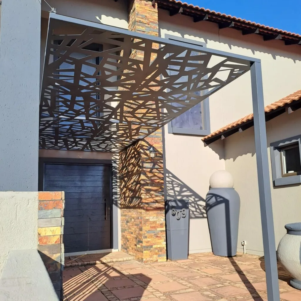 Steel pergola with decorative side and roof panels