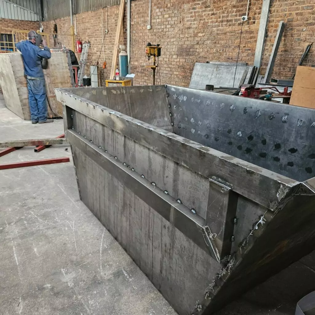 Unpainted steel skip bin with reinforced walls