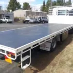 Custom steel flatbed truck body with open loading deck