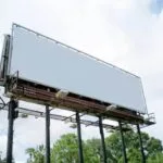 Steel roadside billboard with a blank advertising panel