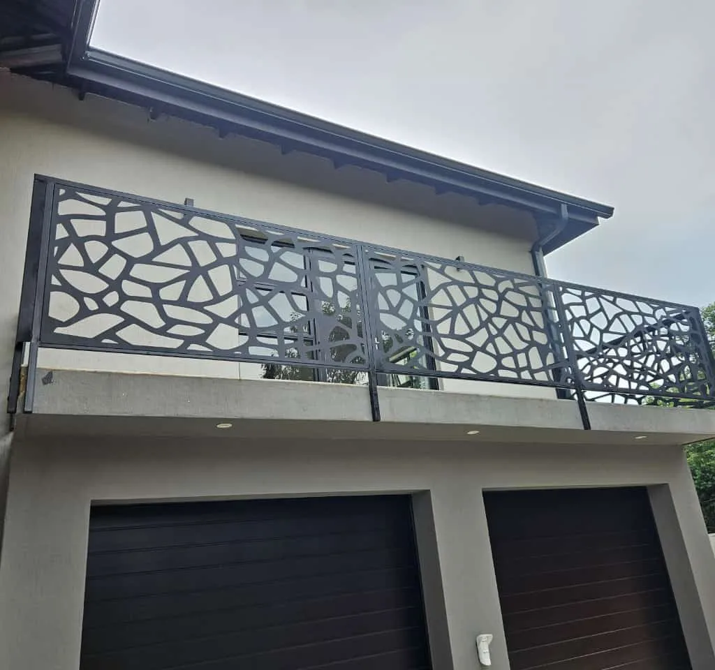 Decorative steel balcony railing with patterned cut-out panels
