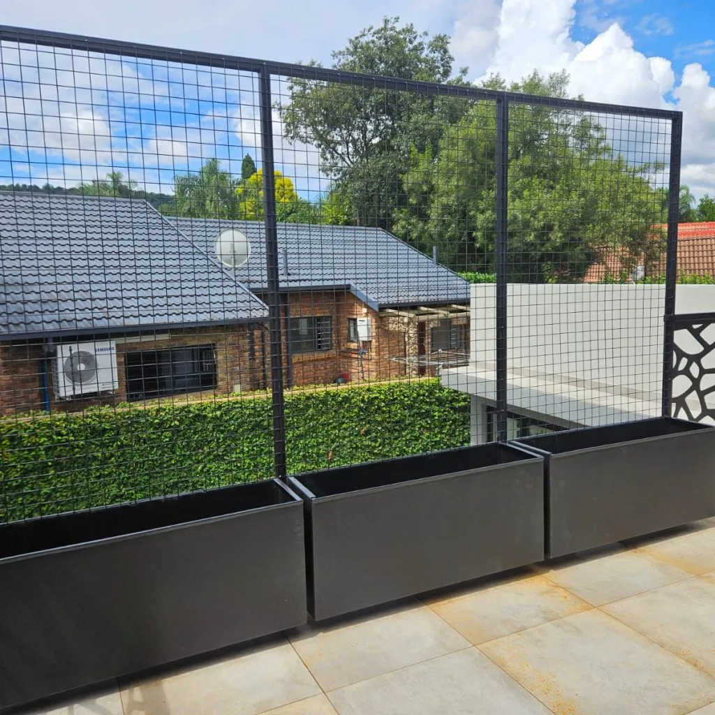 Metal mesh safety railing along an elevated outdoor platform