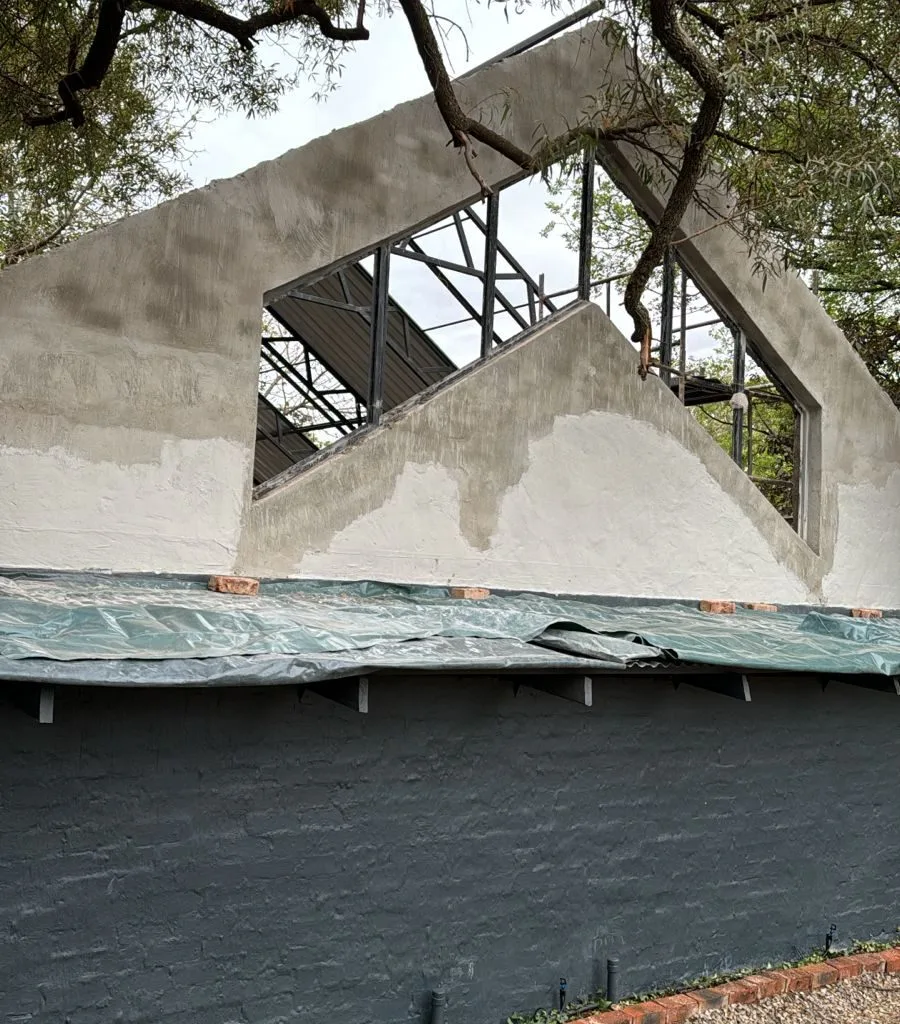 Steel framing beneath trees during construction