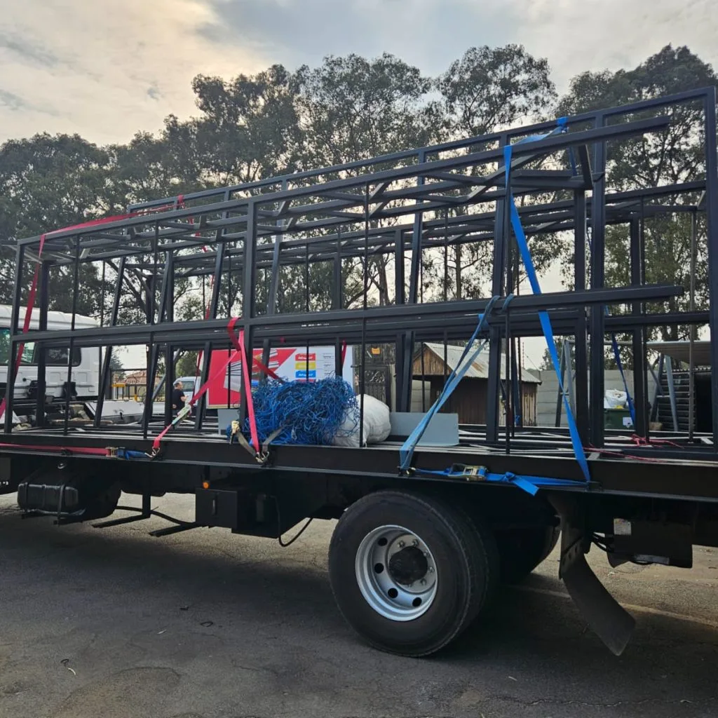 Steel roof trusses installed above a construction work area
