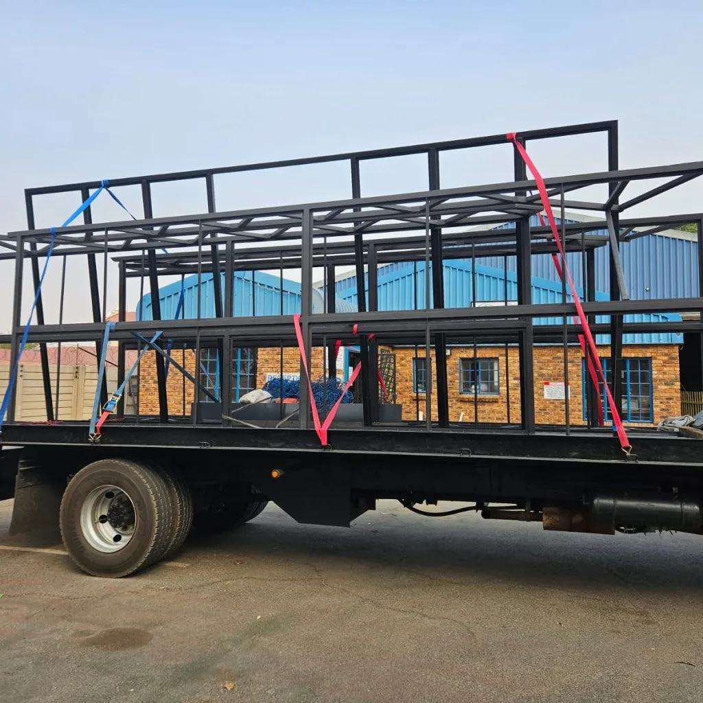 Structural steel frame under construction with columns and roof beams