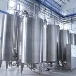 Vertical steel storage tanks installed inside an industrial facility