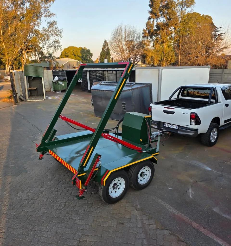 Steel skip bin trailer frame in a workshop yard