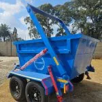 Blue steel skip bin trailer with raised loading frame