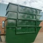 Green steel skip bins stacked for storage