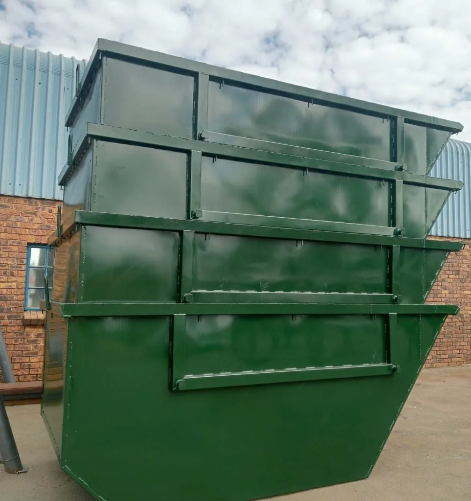 Green steel skip bins stacked for storage