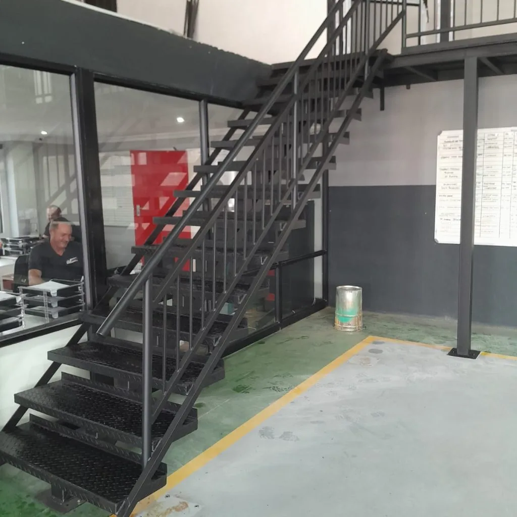 Steel staircase leading to a warehouse mezzanine floor