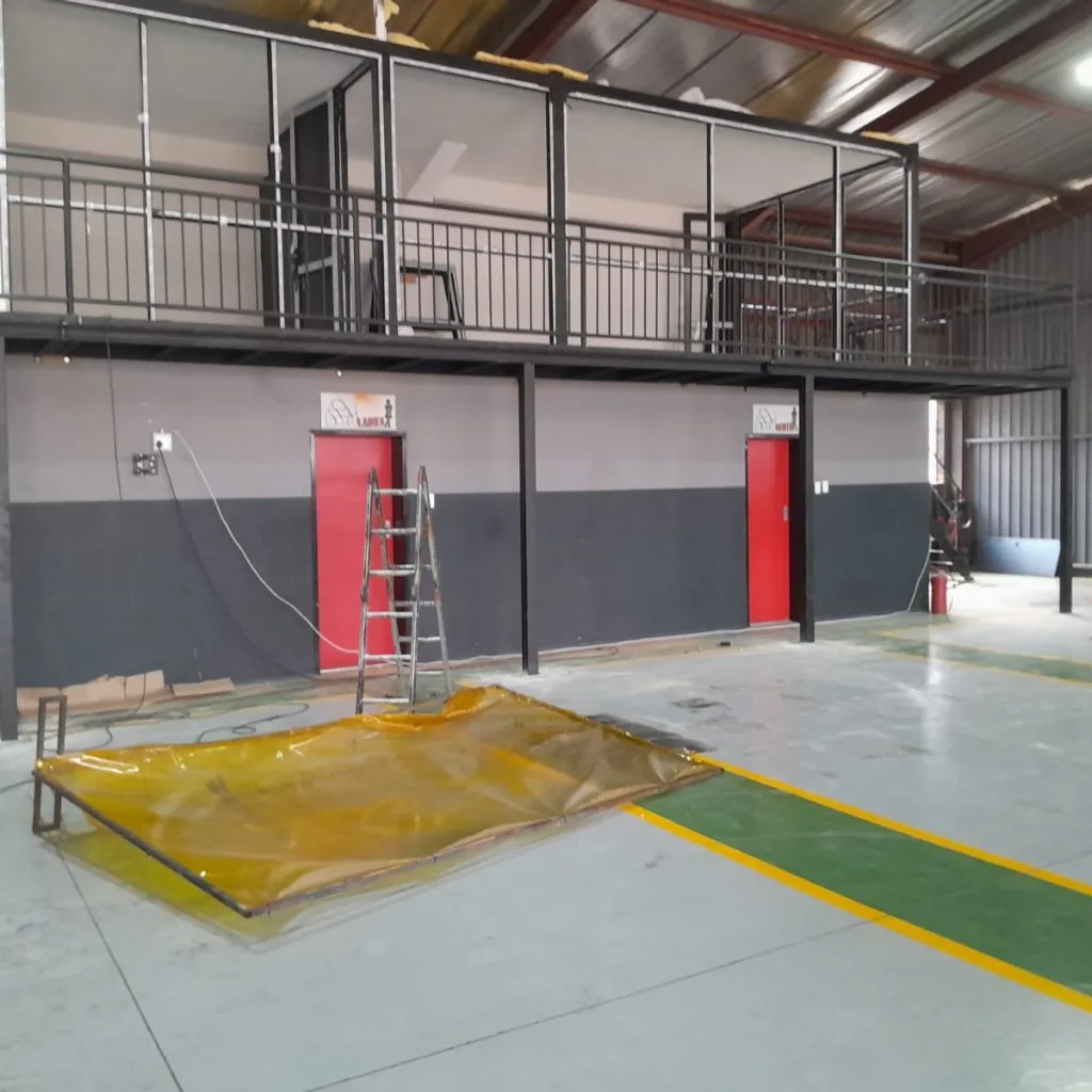 Steel mezzanine platform above warehouse rooms