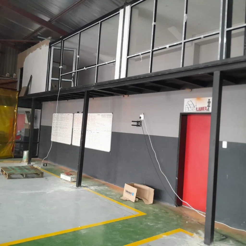 Warehouse mezzanine offices enclosed with framed panels