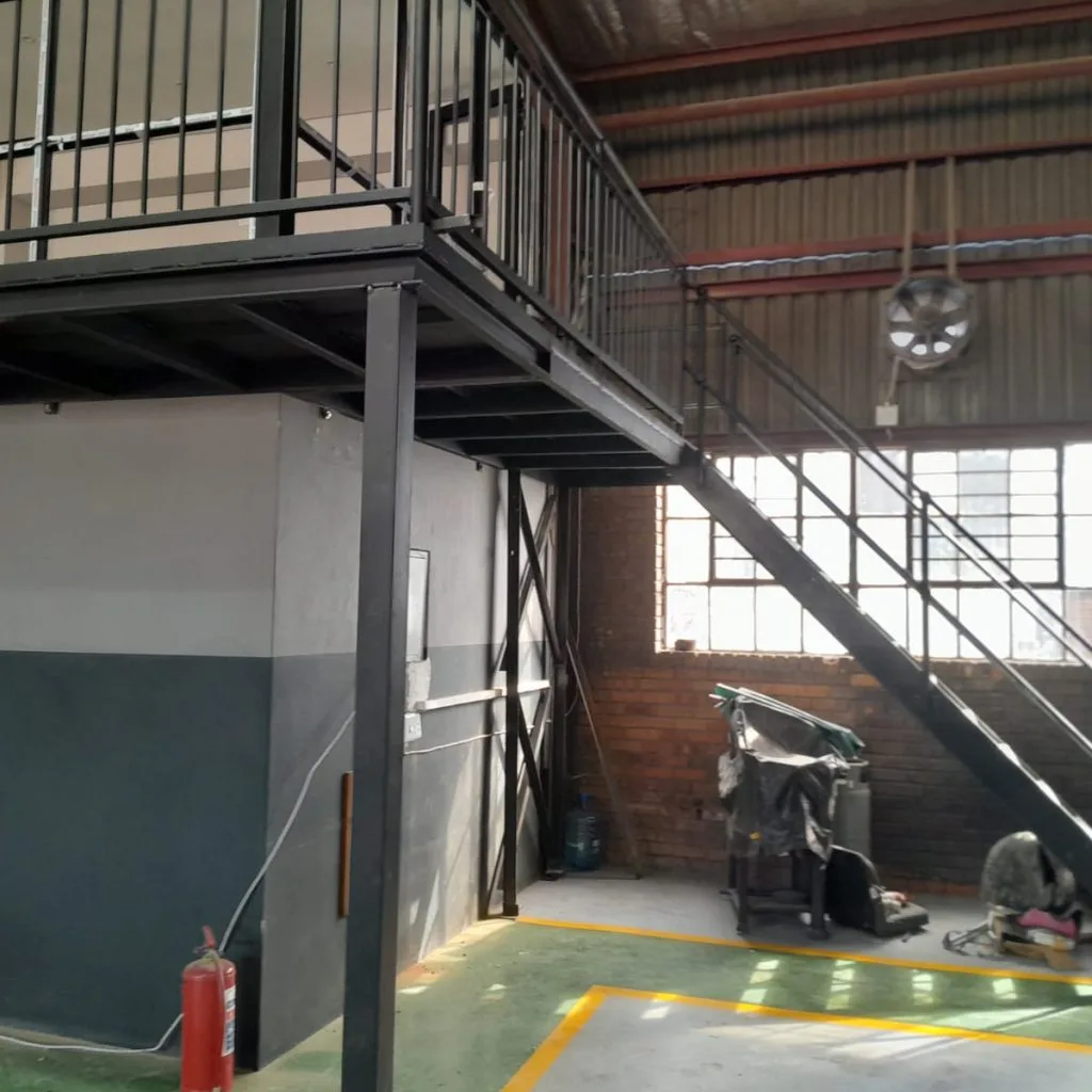 Steel mezzanine staircase and supporting columns