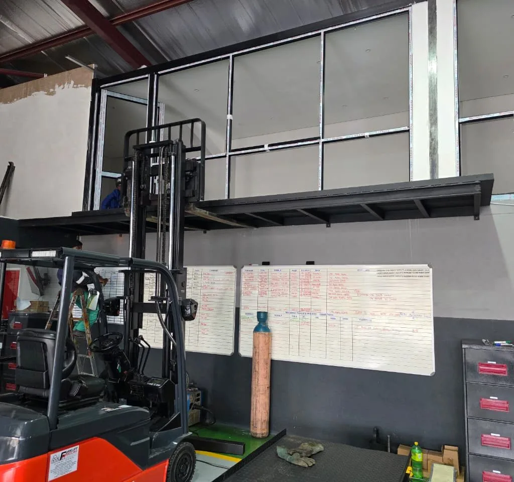 Steel mezzanine structure above a warehouse work area