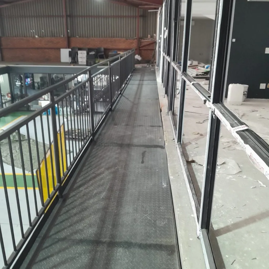 Mezzanine walkway beside enclosed warehouse offices