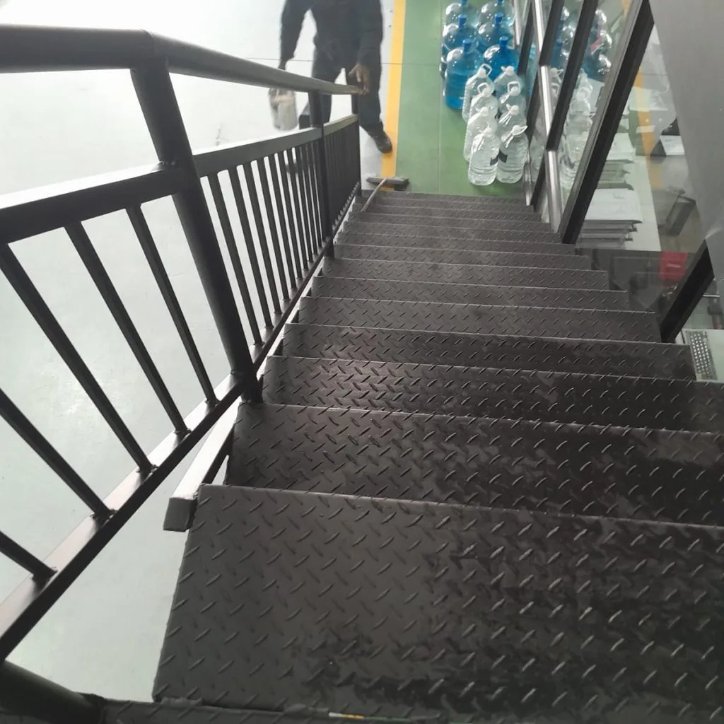 Steel stair treads and handrails leading to a mezzanine