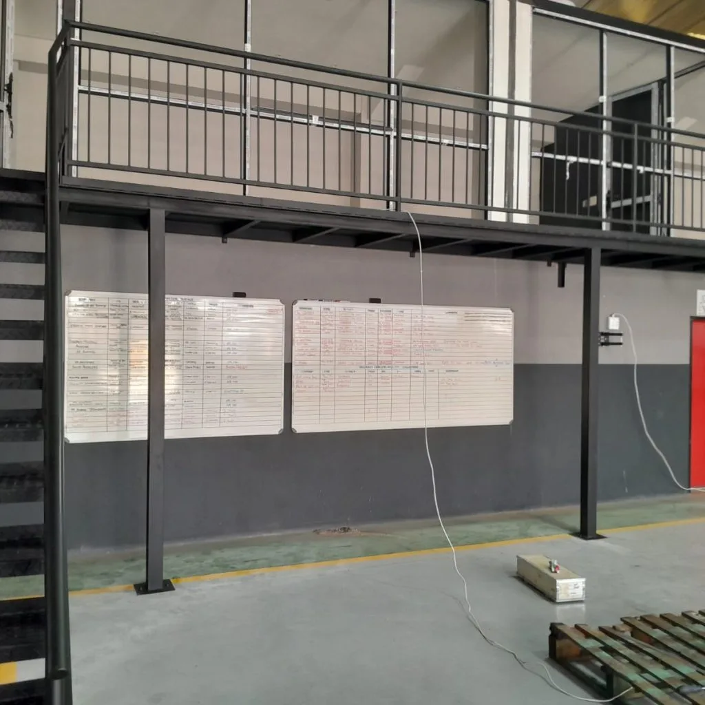 Steel staircase and mezzanine guardrails inside a warehouse