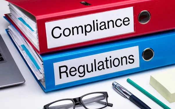 Binders labelled Compliance and Regulations